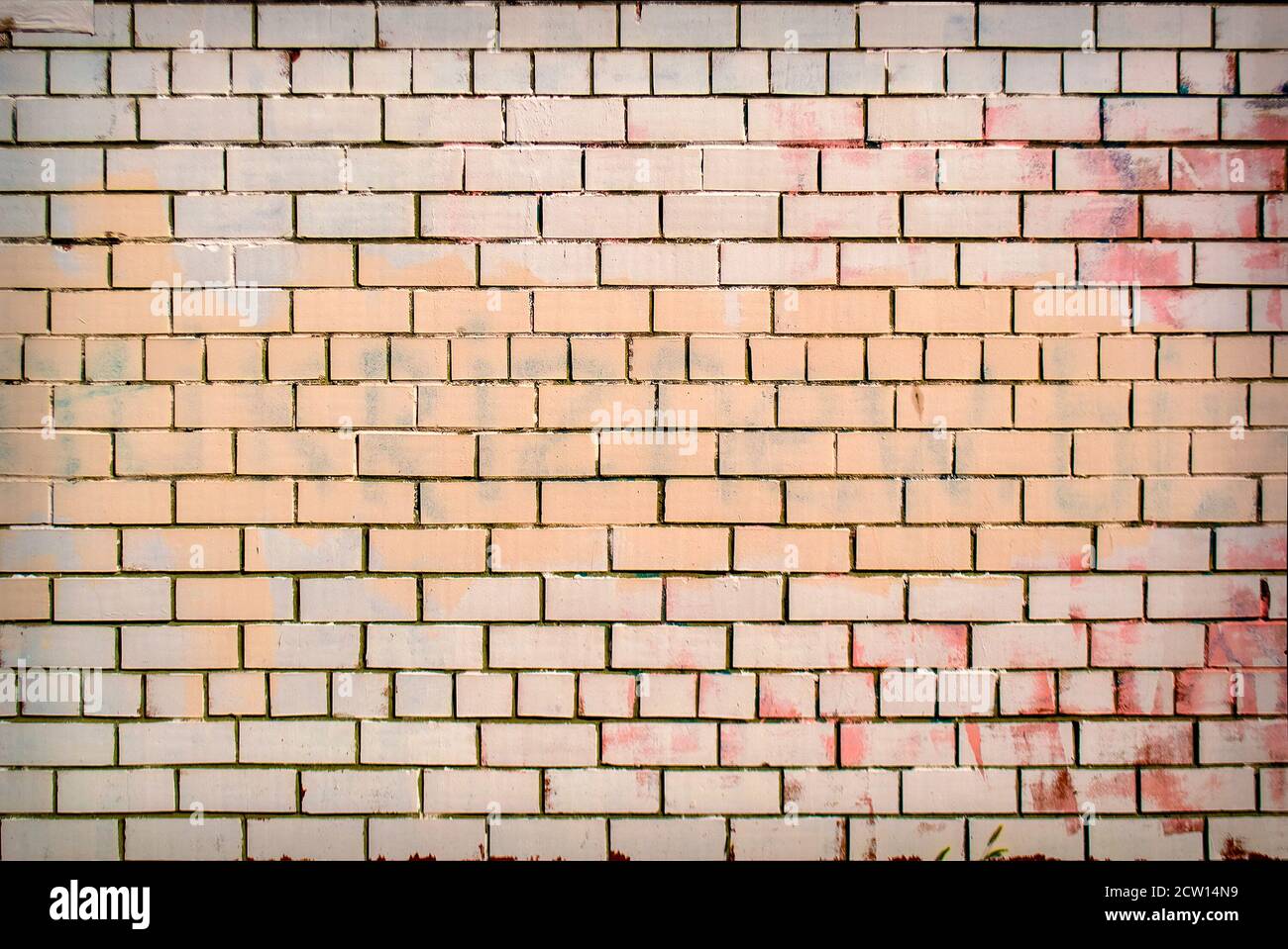 Old grunge painted brick wall texture with delicate vignetting. Stock Photo