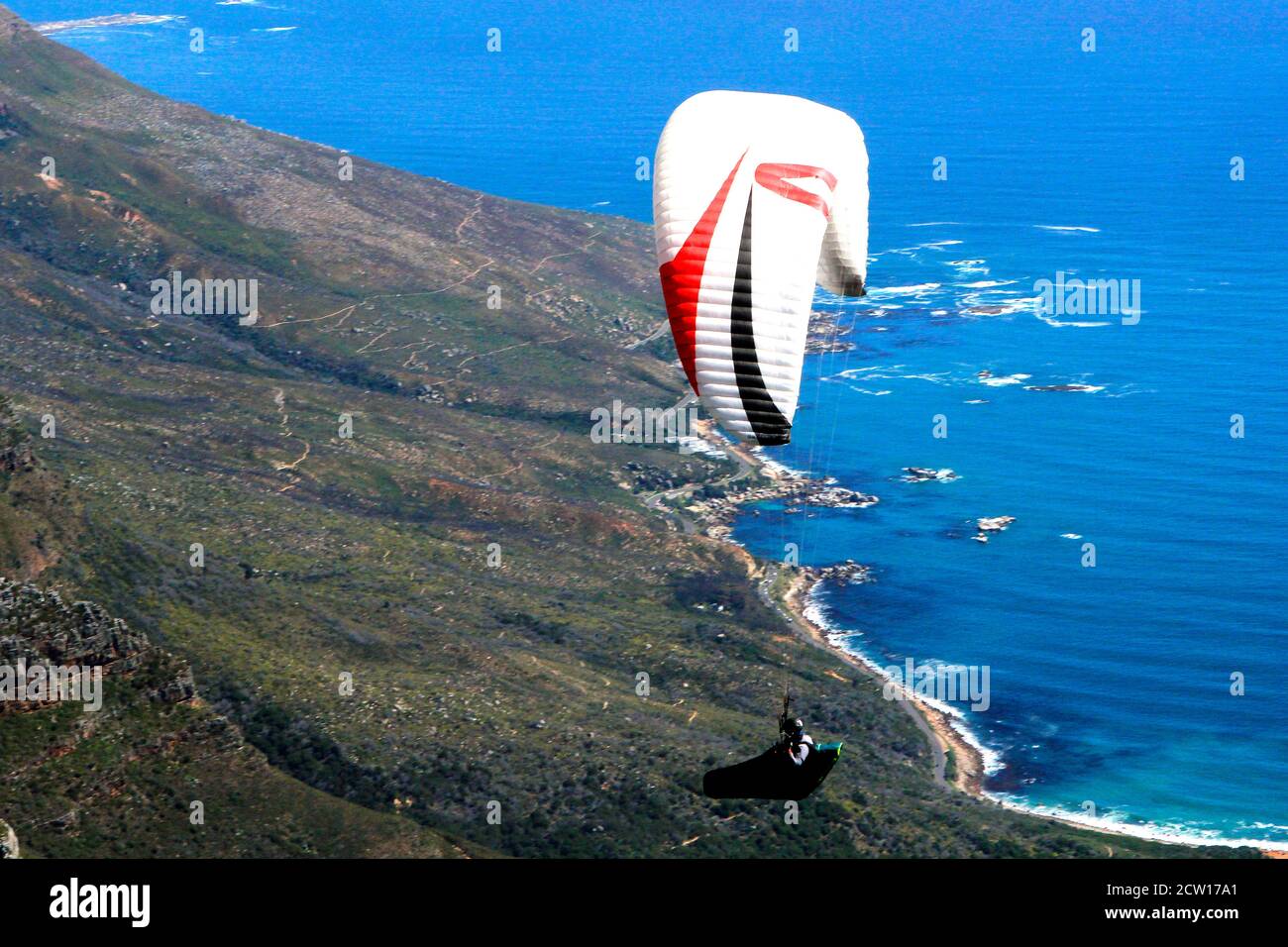 A solo paraglider flying over Table Mountain in Cape Town. Stock Photo