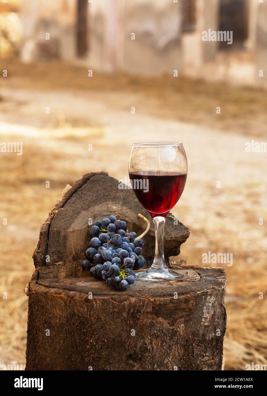 Red wine glass and bunch of grapes on a old wooden background. Image ...