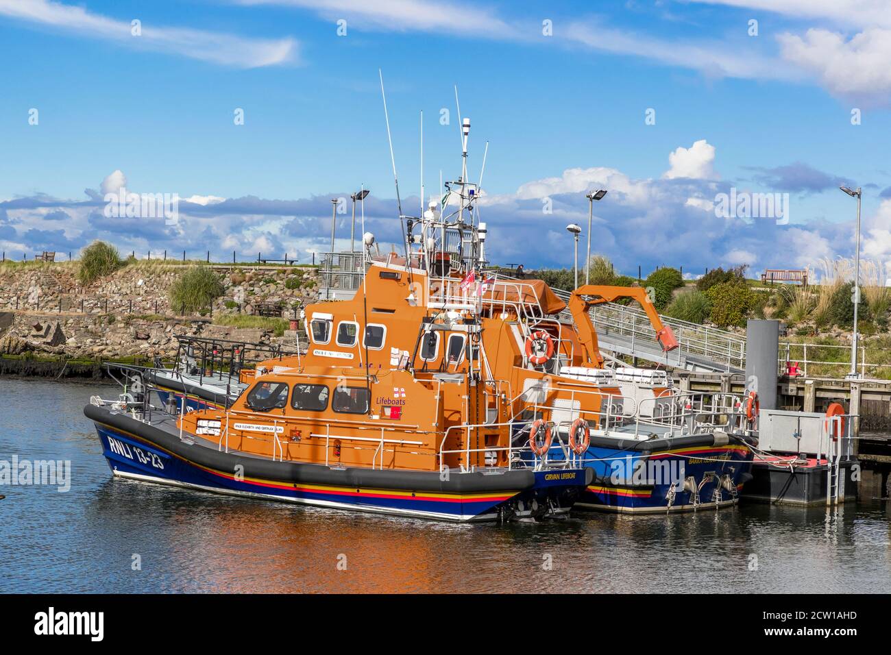 Two RNLI lifeboats, the Girvan lifeboat and the Barra Island lifeboat, tied up at Girvan harbour, Girvan, Ayrshire, Scotland, UK on the Firth of Clyde Stock Photo