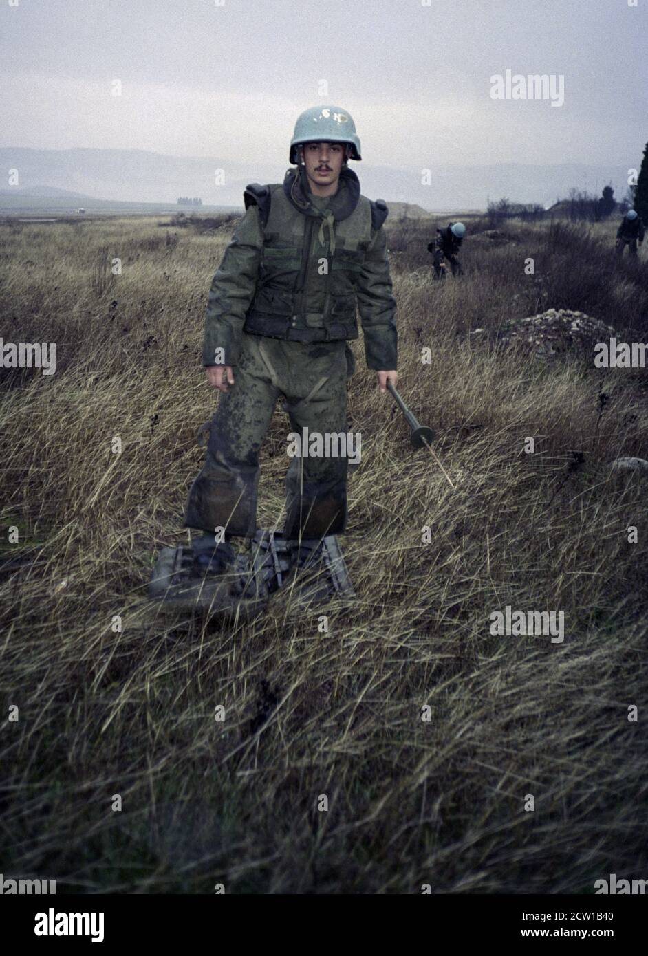 18th December 1995 During the war in Bosnia: French soldiers conducting mine clearance in heavy rain, around the runway at Mostar airport. Stock Photo