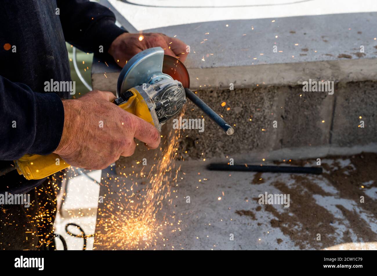 Metal industry worker grinding steel bar Stock Photo Alamy