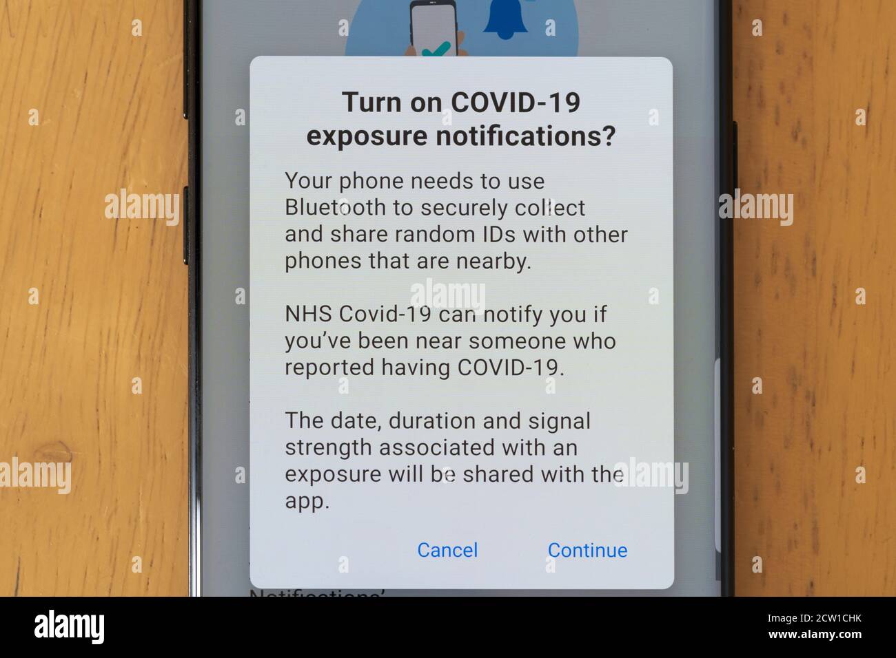 NHS Test and Trace App on a smartphone with a request screen for permissions to turn on exposure notifications for Covid-19. Privacy concerns Stock Photo