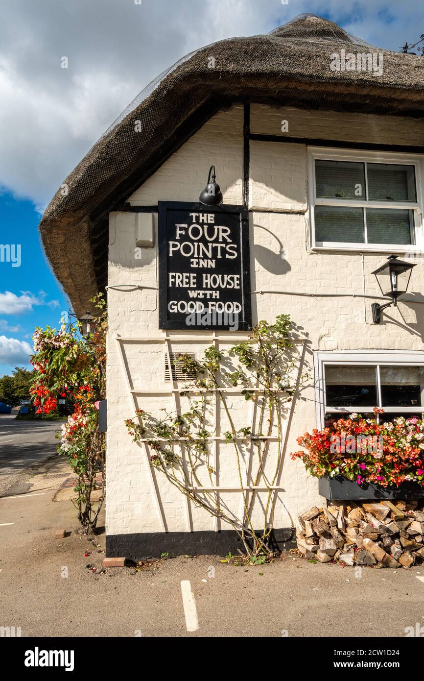 The Four Points Inn, a village pub and restaurant in Aldworth, Berkshire, UK. Exterior of the public house decorated with flowers and hanging baskets Stock Photo