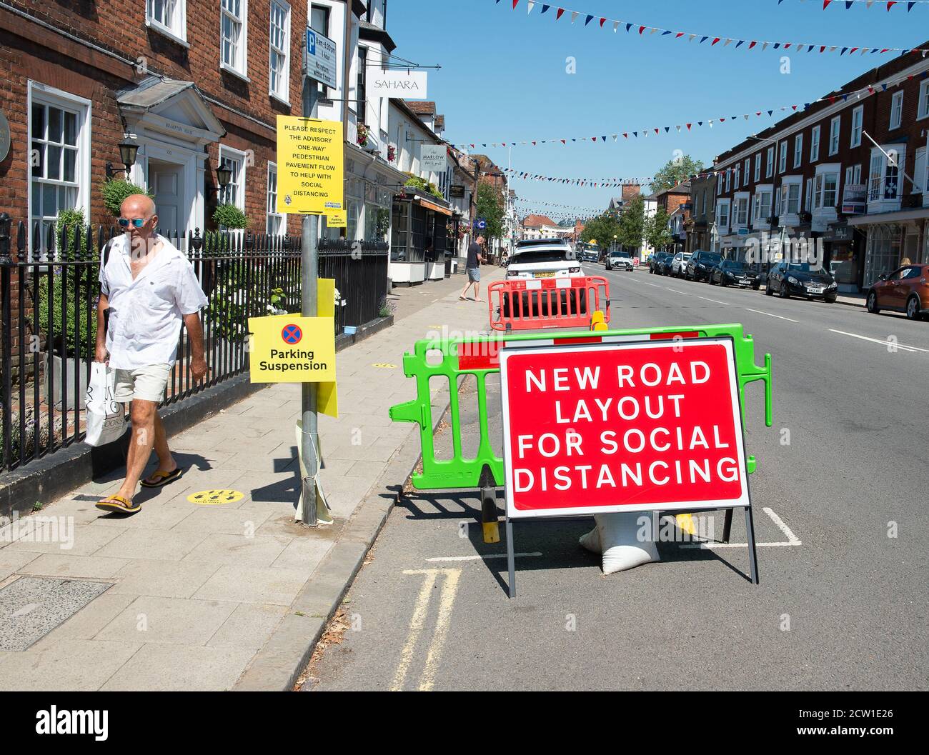 Marlow, Buckinghamshire, UK. 25th June, 2020. A new road layout sign for social distancing in Marlow High Street which remains quieter than normal even though many of the shops have now reopened for business following the easing of the Coronavirus Covid-19 Pandemic lockdown rules. Credit: Maureen McLean/Alamy Stock Photo