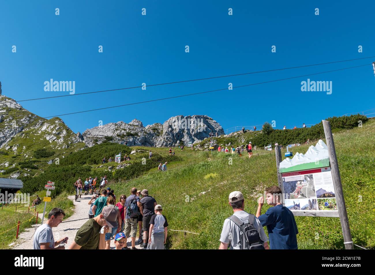 Tourists go hiking in the area arround mountain station from the Alpspitze cable car. Stock Photo