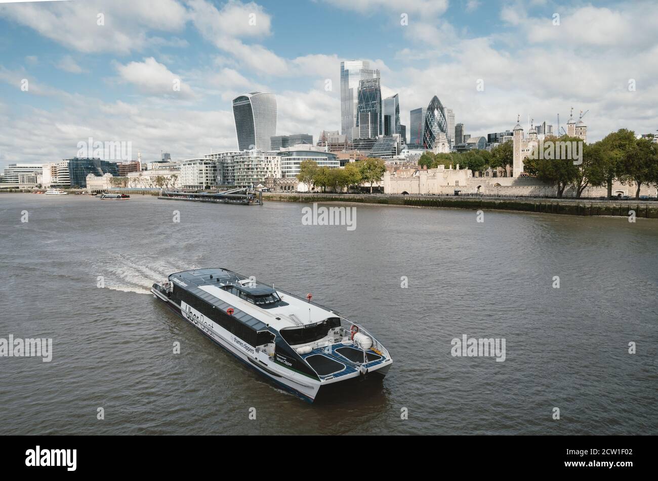 Panoramic view of London from the river Thames with boat in the foreground and the City of London in the background Stock Photo