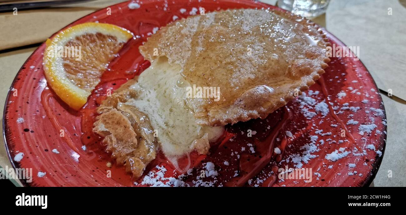 Seada, typical fried sardinian dessert with acid cheese and honey Stock Photo