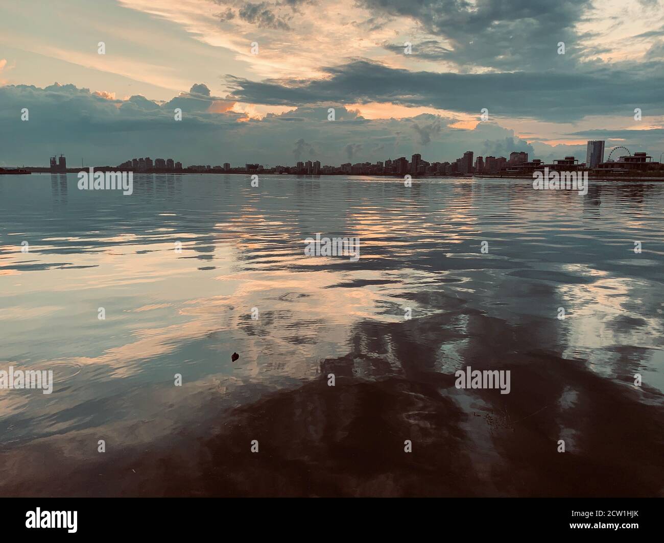 Sunset over city and the river Stock Photo - Alamy