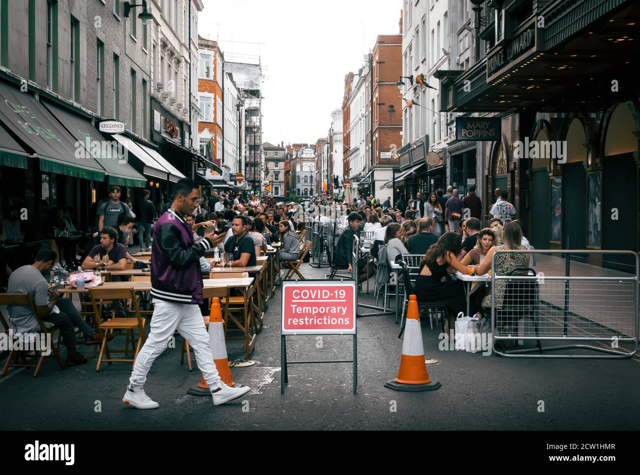 London - 22 August 2020 - View of Red Covid-19 Temporary Restriction Sign in Crowded Location in Soho, London UK Stock Photo
