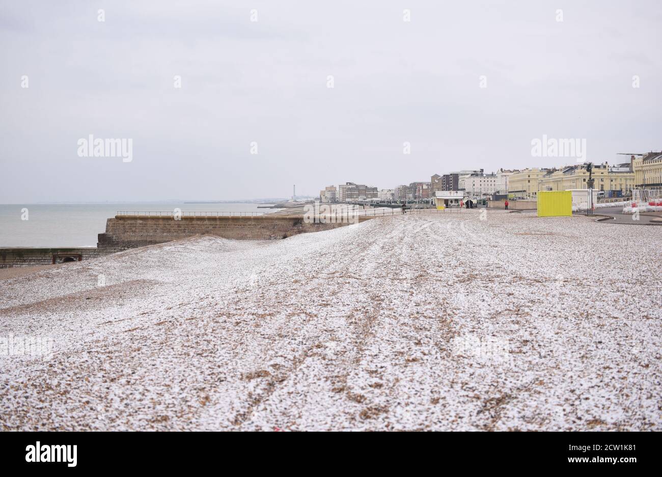 A cold morning on Brighton beach, with snow on the pebbles Stock Photo