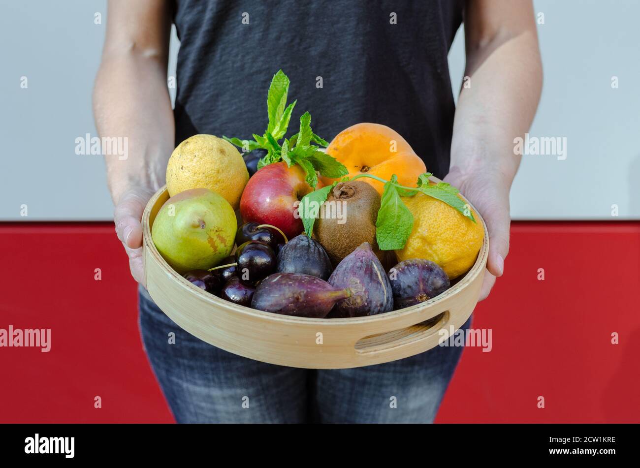 woman offering a tray of organic fruits Stock Photo Alamy