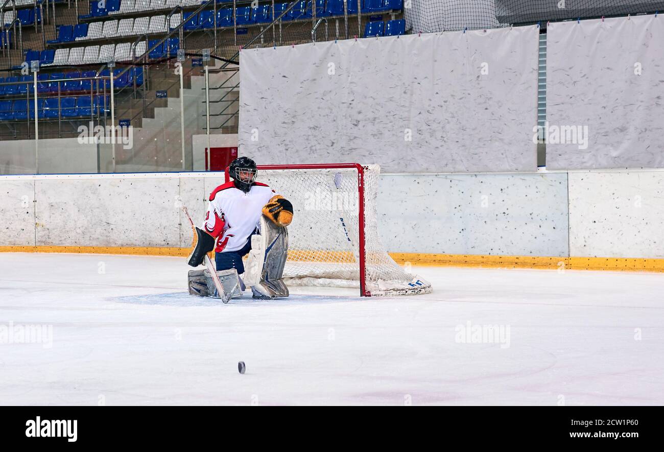 hockey goalie hits the puck Stock Photo Alamy