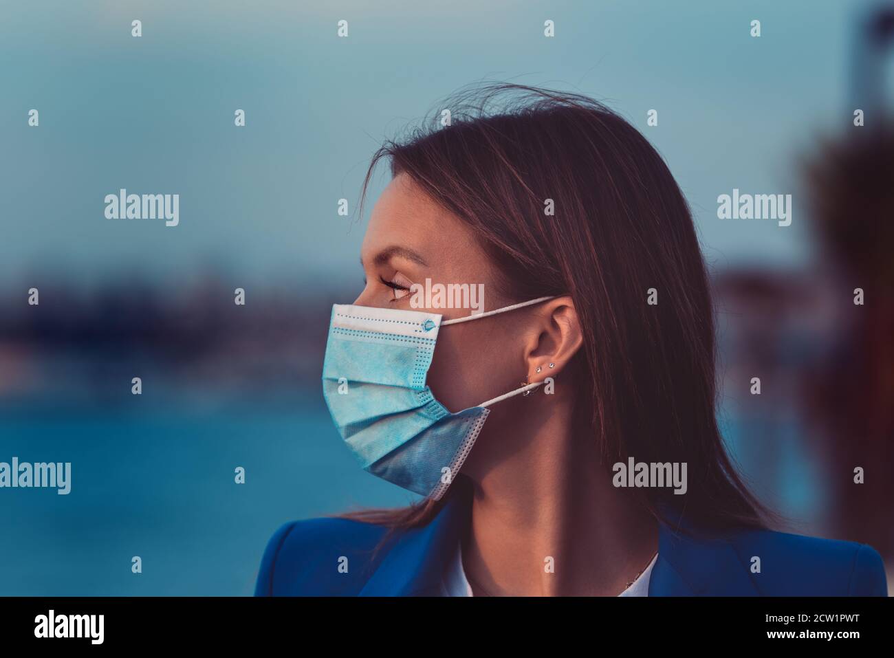 Brunette in blue disposable mask hi-res stock photography and images ...