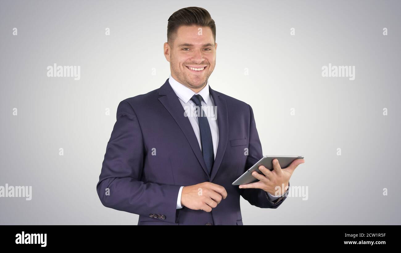 Expressive young businessman with tablet presenting something sw Stock Photo