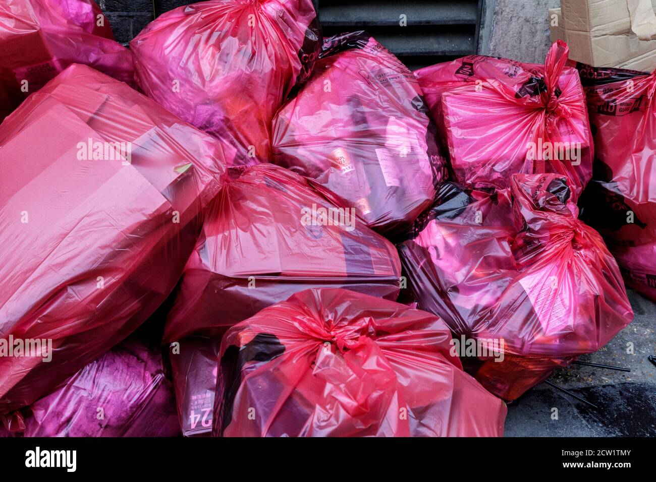 Bags of trash pile up on the sidewalk in London, England. Stock Photo