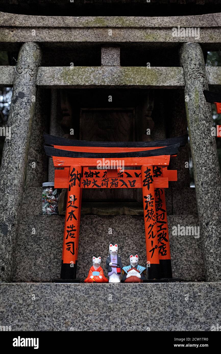 Miniature Torii gate with fox/ inari figures at Fushimi Inari Shrine. Kyoto, Japan Stock Photo