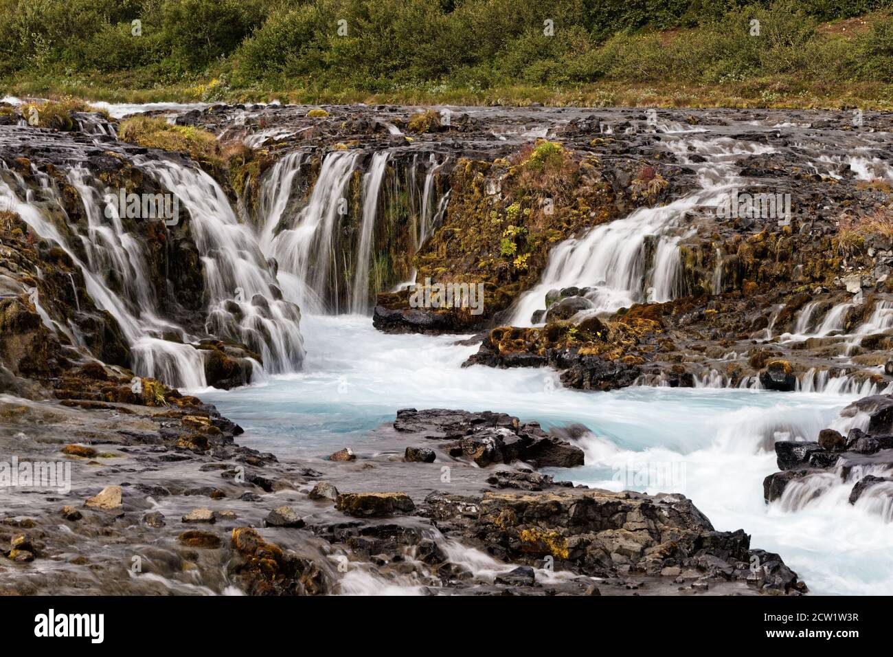 Scenic view of a wild waterfall with many individual watercourses at a rock stage in the evening light, close up - Location: Iceland, Golden circle, B Stock Photo