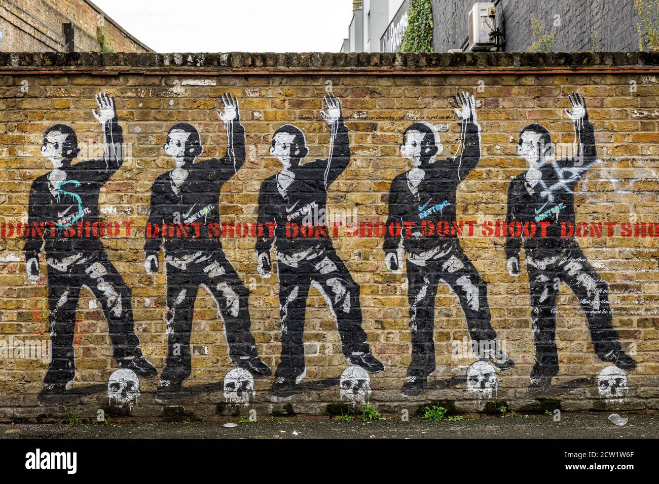 Graffiti art on a wall depicts images opposing police violence and corporate power in London, United Kingdom. Stock Photo