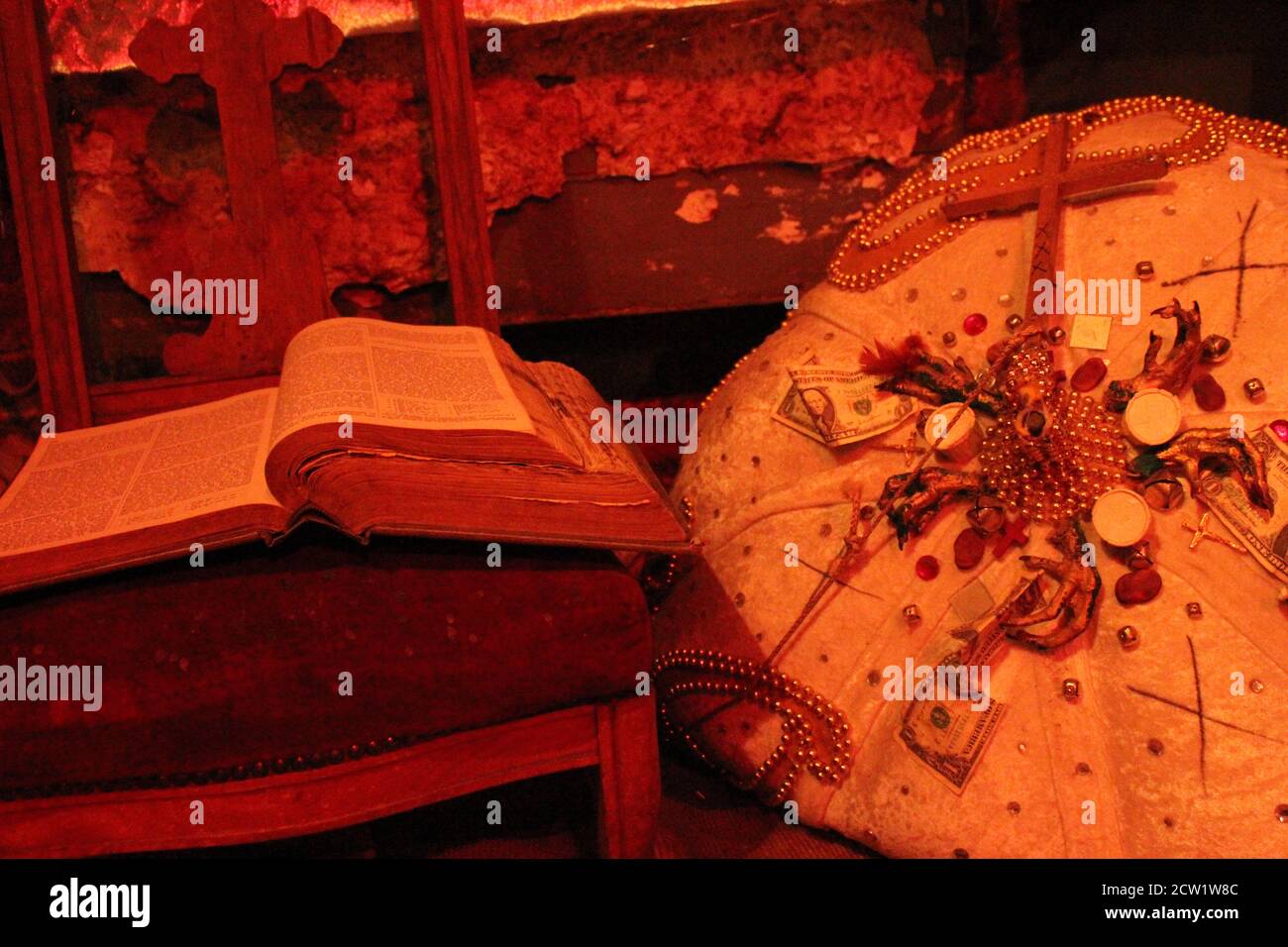 Altar of offerings- book on chair next to pin cushion for Marie Laveau Stock Photo