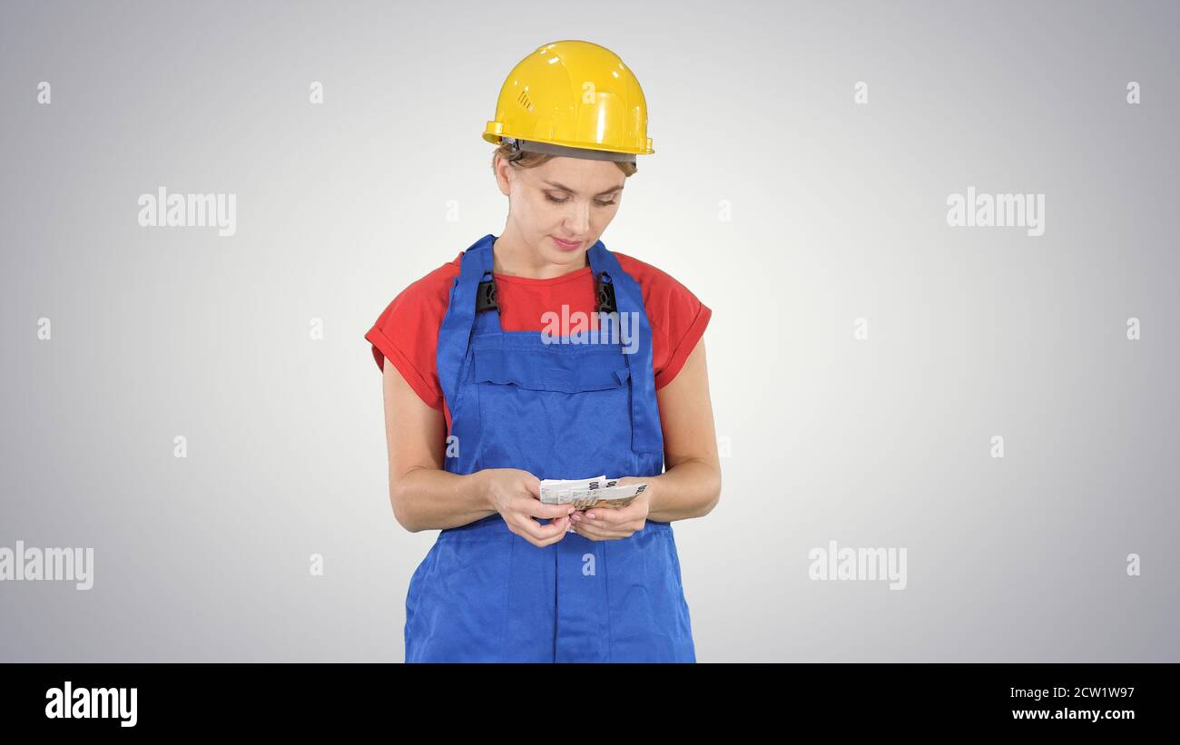 Young cheerful female worker holding salary banknotes in euro on Stock Photo