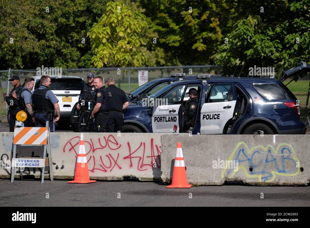 Portland, USA. 29th May, 2020. Protesters walk by graffiti on the Louis  Vuitton store in Portland, Ore., on May 29, 2020. (Photo by Alex Milan  Tracy/Sipa USA) Credit: Sipa USA/Alamy Live News