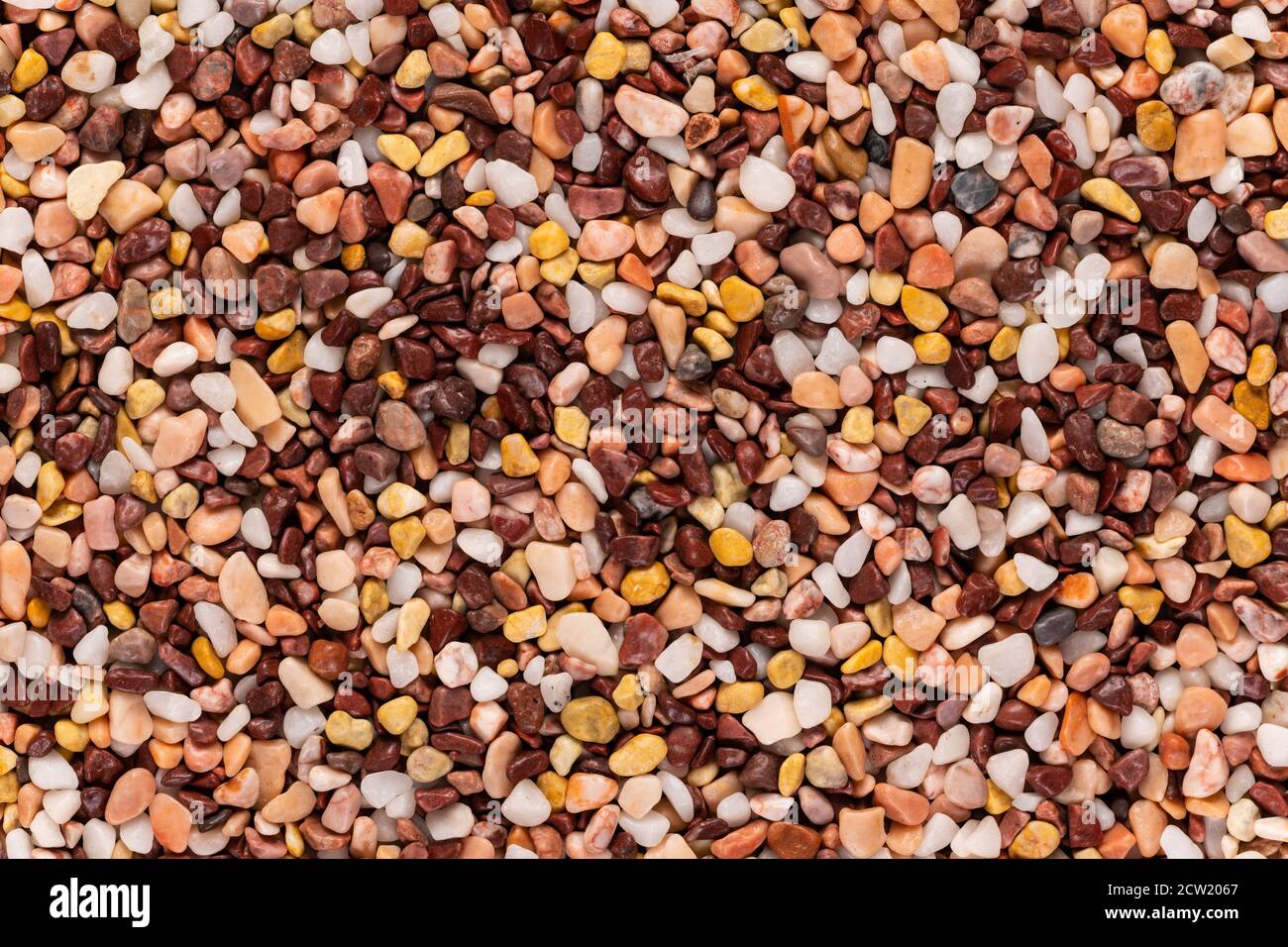 Multi-colored small river stones texture and background. Stock Photo