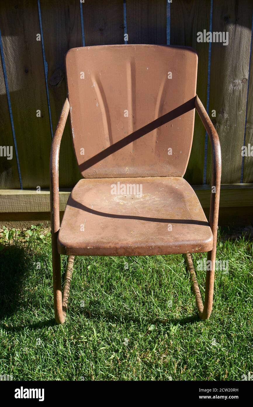 Vintage, brown, metal patio chairs in yard Stock Photo Alamy