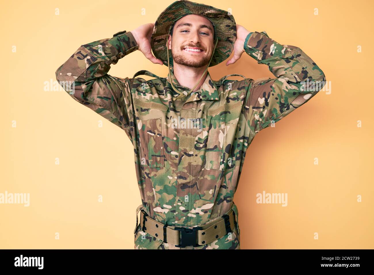 Young caucasian man wearing camouflage army uniform relaxing and ...