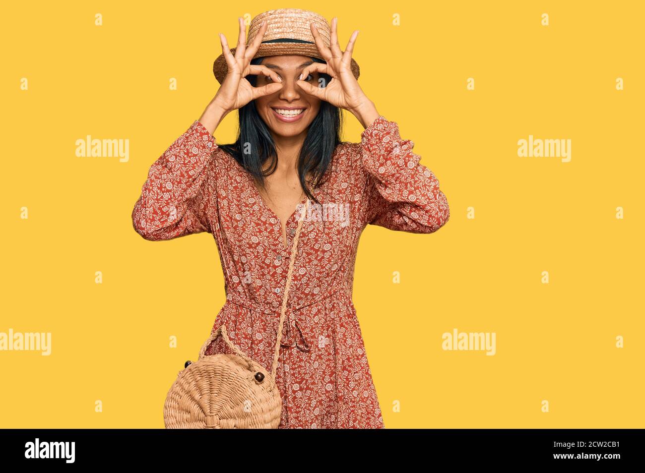 Young african american woman wearing summer hat doing ok gesture like ...