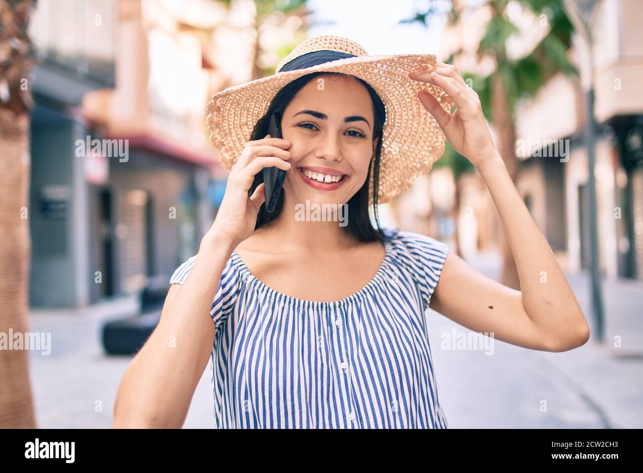 Young latin tourist girl on vacation smiling happy talking on the ...