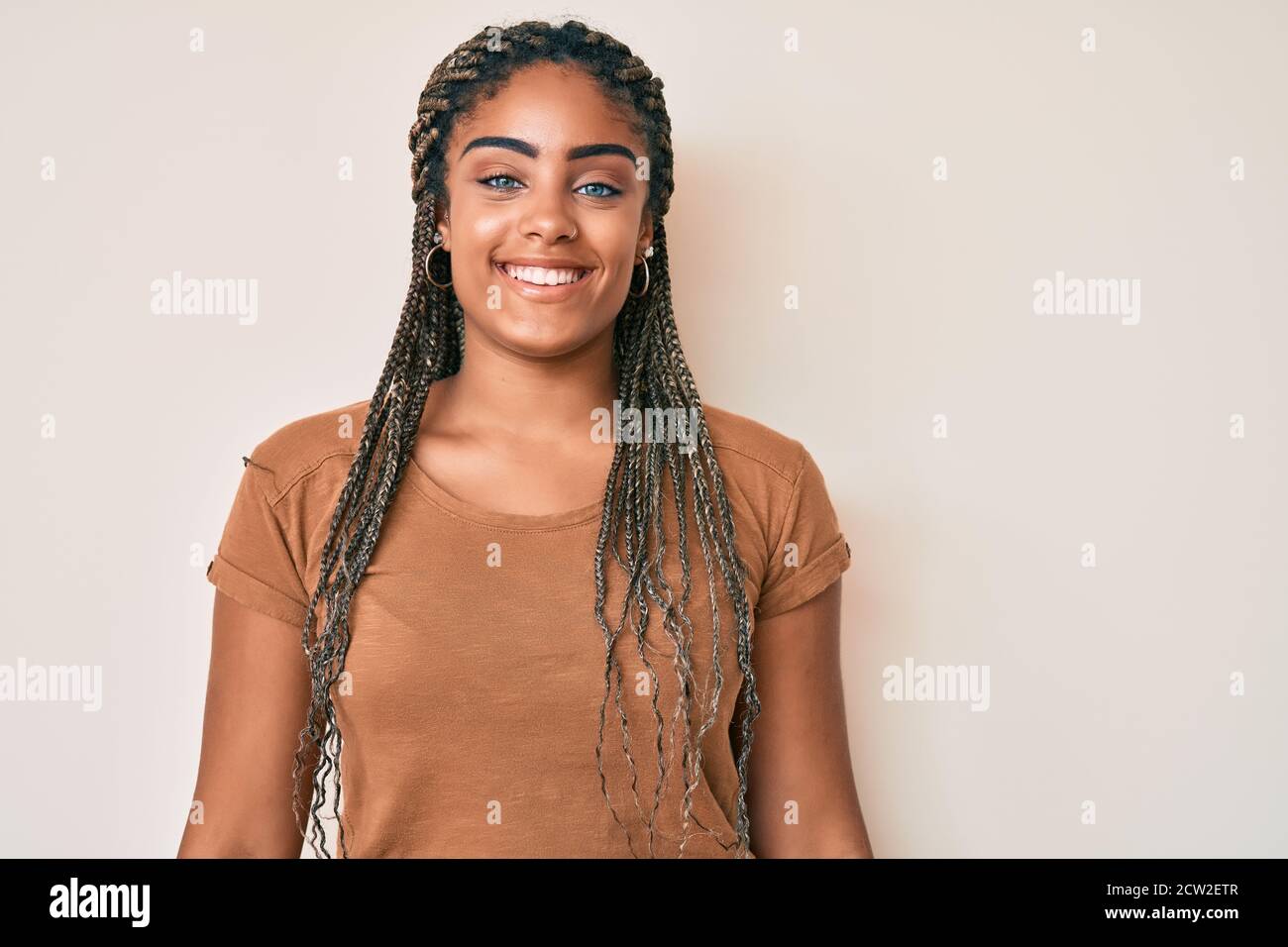 Young african american woman with braids wearing casual clothes looking ...