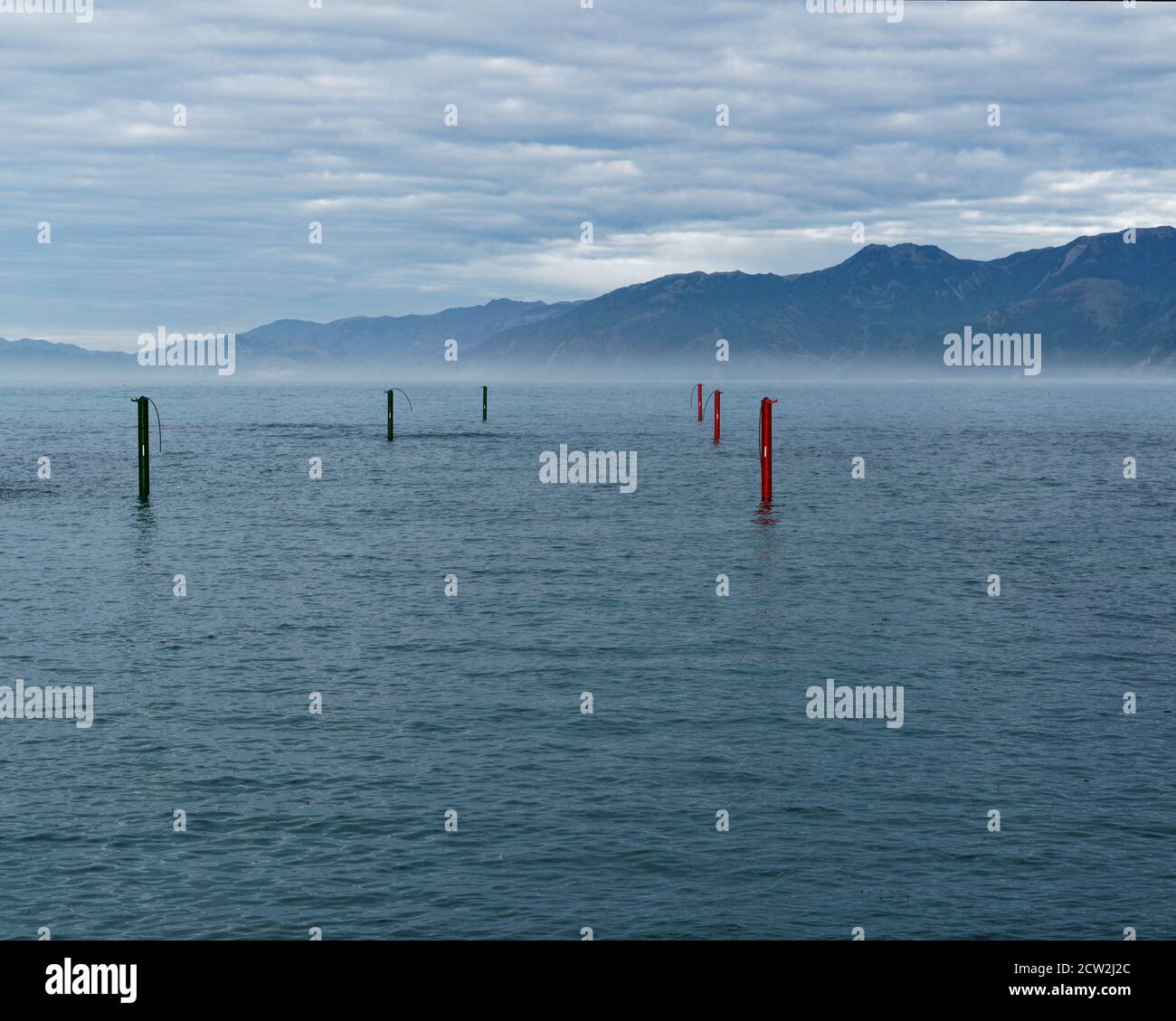South Bay harbour, entrance and exit marker poles, Kaikoura, south island, New Zealand. Stock Photo