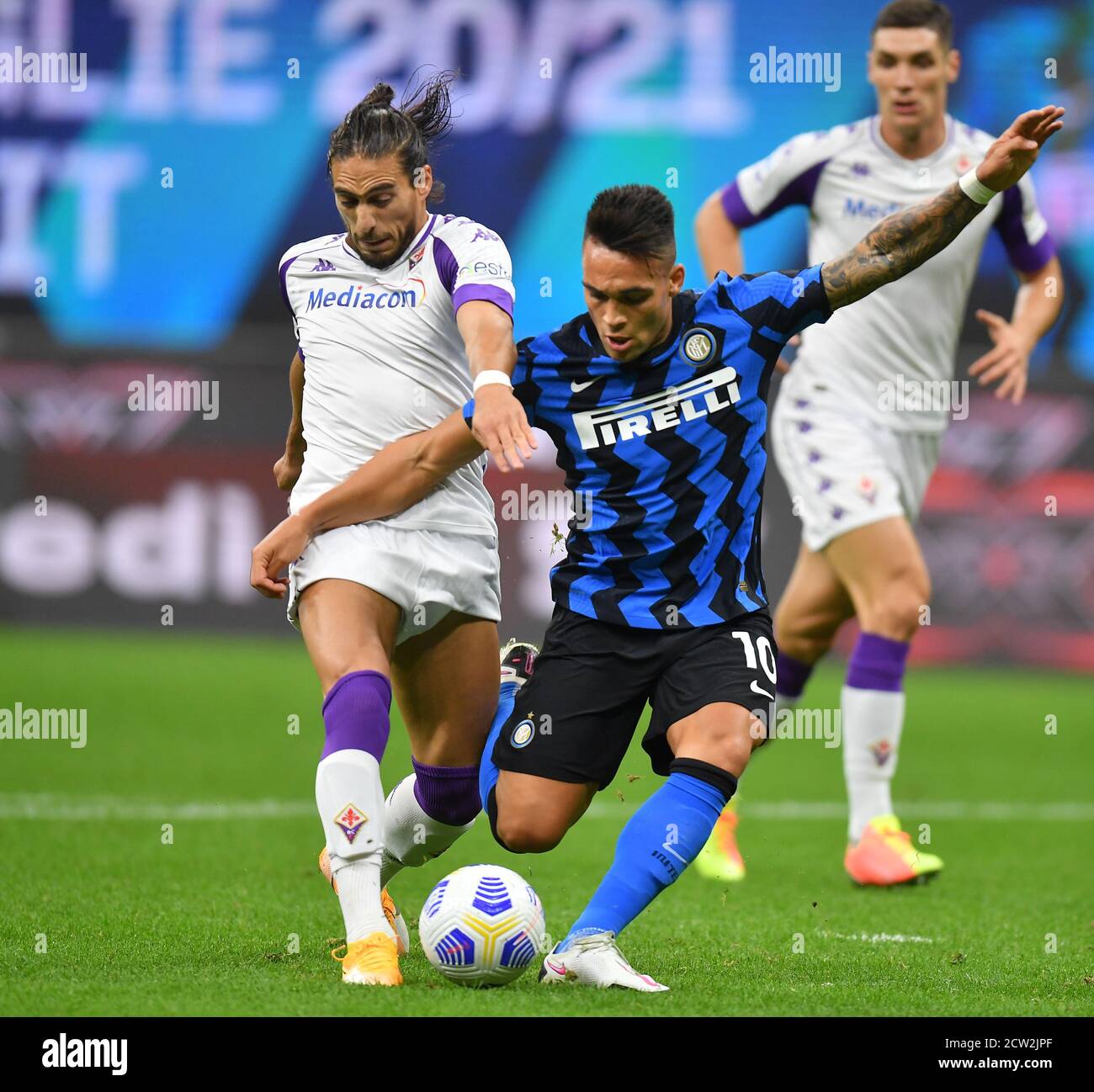 Milan, Italy. 26th Sep, 2020. FC Inter's Lautaro Martinez (R) vies with Fiorentina's Martin Caceres during a Serie A soccer match between FC Inter and Fiorentina in Milan, Italy, Sept. 26, 2020. Credit: Alberto Lingria/Xinhua/Alamy Live News Stock Photo