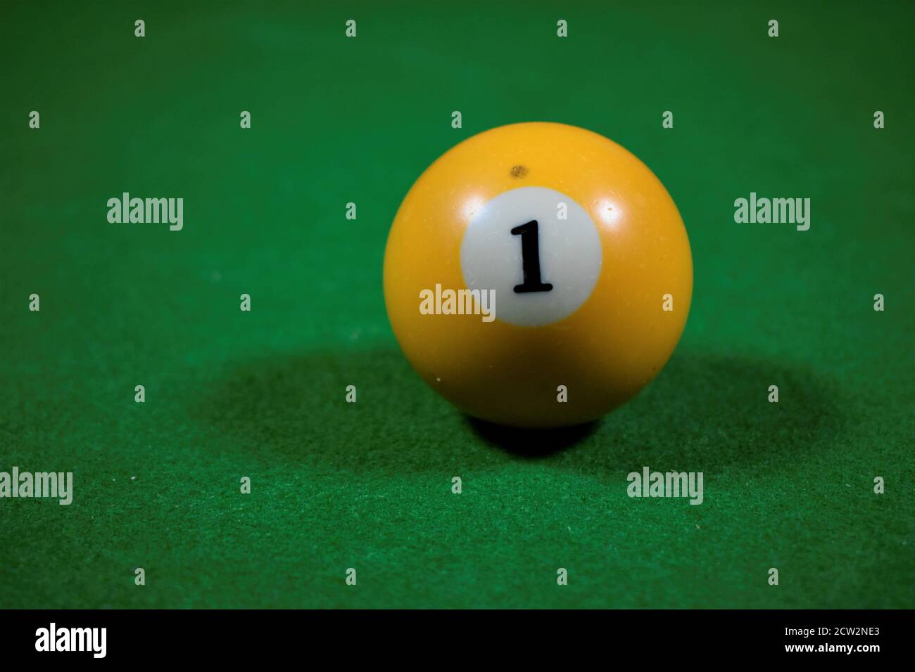 billiard table with number one yellow balls. billiards background Stock