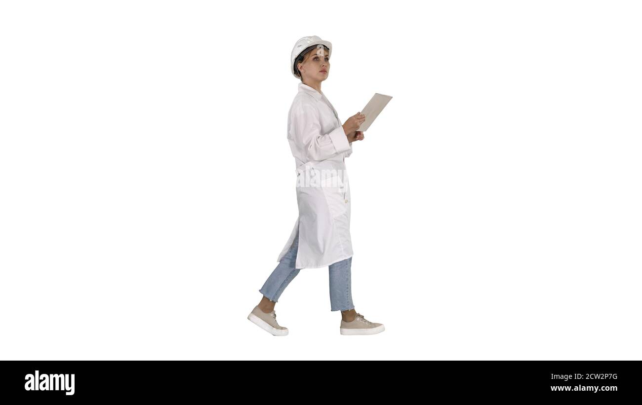 Young technician inspecting and taking necessary notes on digita Stock Photo