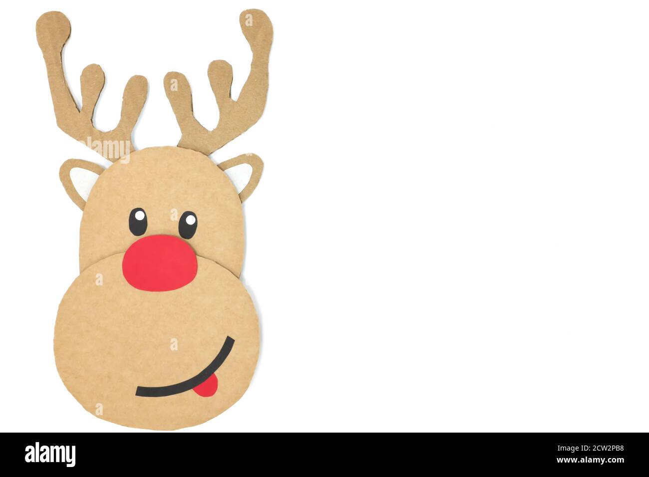 Cute and happy baby reindeer cardboard cutout with red nose isolated on a white background. Christmas is coming concept. Copy space. Stock Photo