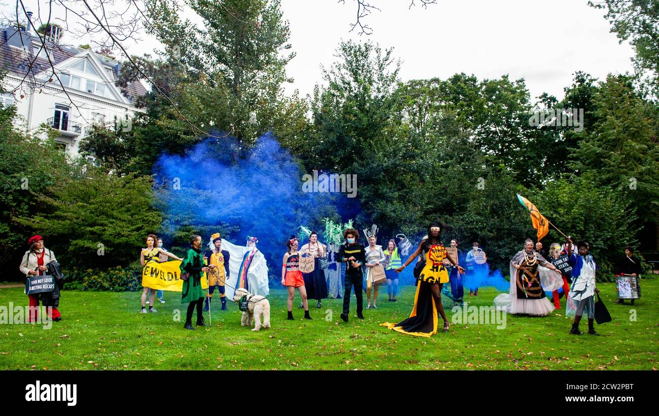 A group of XR (Extinction Rebellion) models posing for the camera in the middle of the park during the demonstration.The label is made by anonymous and ego-free rebels, climate activists from Extinction Rebellion. Inclusivity and diversity are what the label stands for. The label was launched during the celebration of the Dutch Sustainable Fashion Week, and counted with around 18 creations. Through Nopulence, Extinction Rebellion expresses concern on fashion in fashion. While clothes are not for sale, they will be available for activists. Stock Photo
