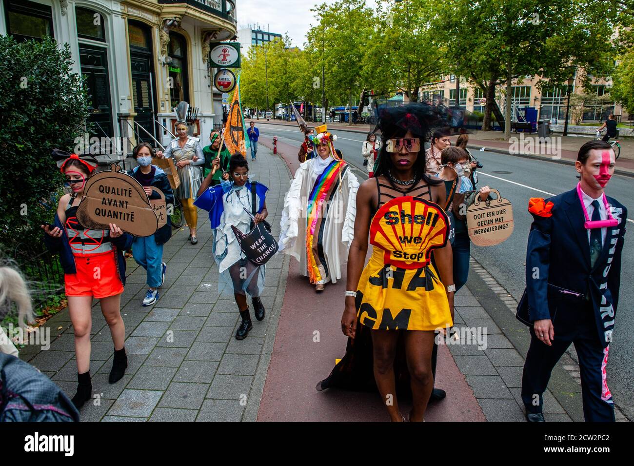 A XR (Extinction Rebellion) model wearing a dress against the oil company Shell during the demonstration.The label is made by anonymous and ego-free rebels, climate activists from Extinction Rebellion. Inclusivity and diversity are what the label stands for. The label was launched during the celebration of the Dutch Sustainable Fashion Week, and counted with around 18 creations. Through Nopulence, Extinction Rebellion expresses concern on fashion in fashion. While clothes are not for sale, they will be available for activists. Stock Photo
