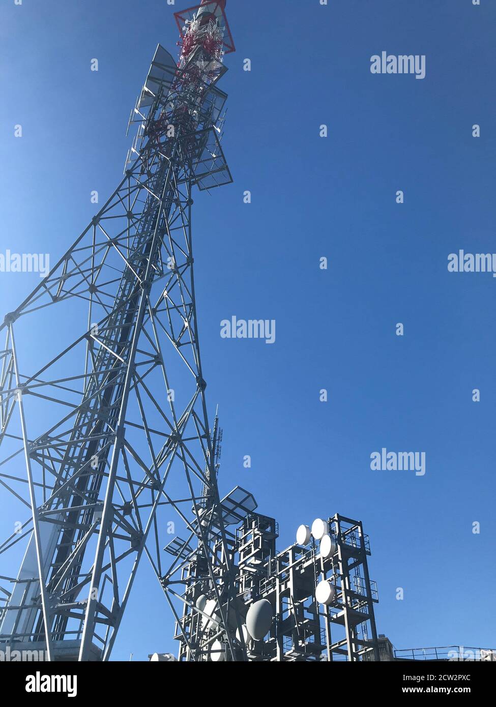 Contrast between technology and nature: The broadcasting tower on the top of the valais peak Gebidum Stock Photo