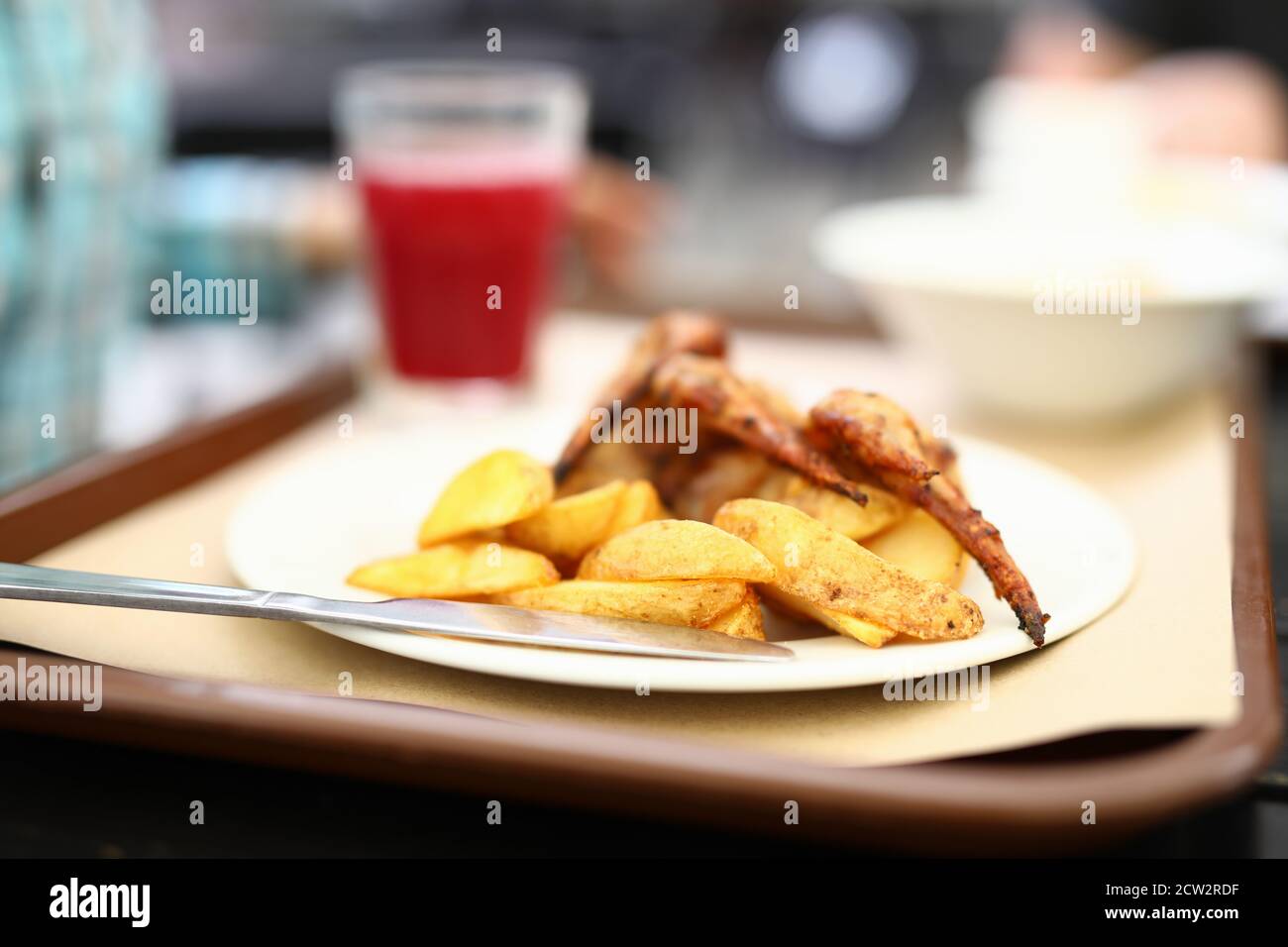 Potatoes and grilled chicken wings on plate. Stock Photo