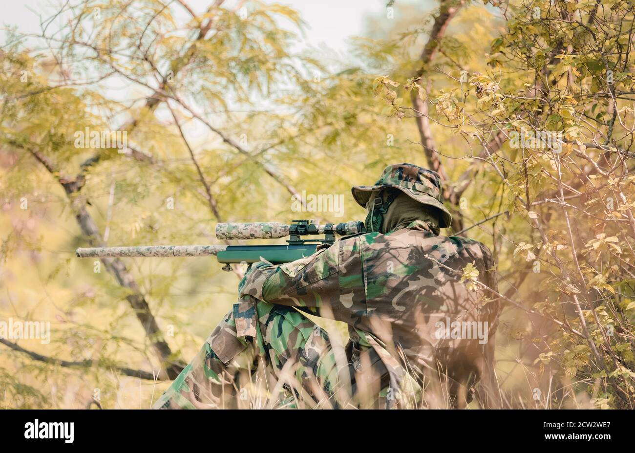 Fully Equipped Soldiers Wearing Camouflage Uniform Attacking Enemy, Airsoft military game player in camouflage uniform Stock Photo