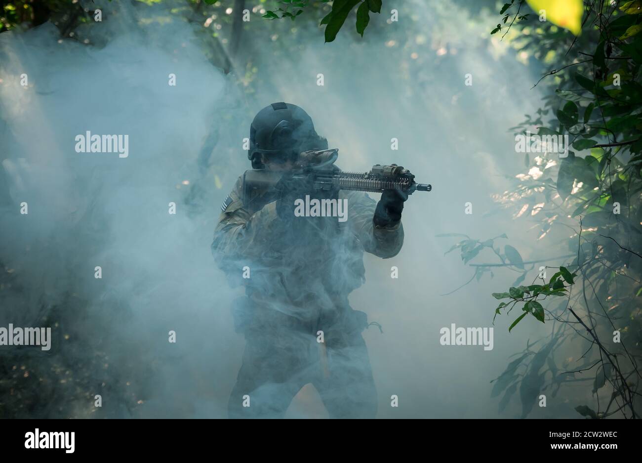 Fully Equipped Soldiers Wearing Camouflage Uniform Attacking Enemy, Airsoft military game player in camouflage uniform Stock Photo