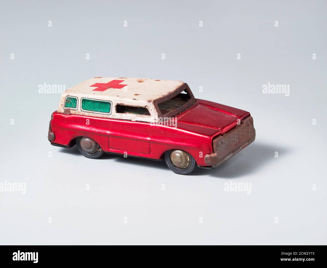 Rustic tin toy vintage ambulance van with red cross symbol Stock Photo