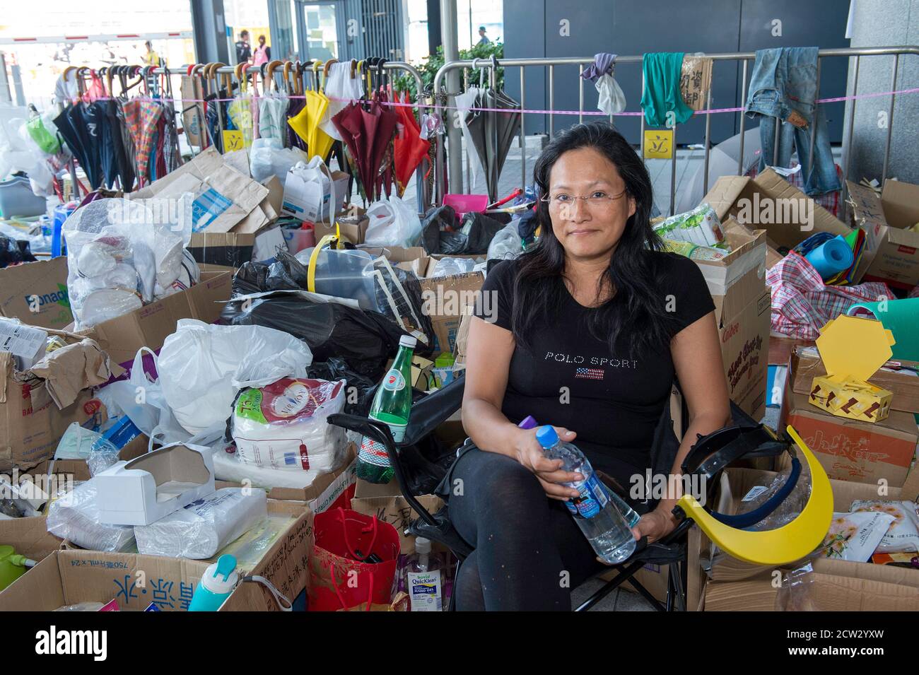 Hong Kong, Hong Kong, China. 5th Oct, 2014. The 2014 Umbrella revolution. Protester SK Liu, 52, runs a amenities stand outside the Chief Executives office at the government complex, Tamar, Admiralty. She is there 24 hours a day providing mask, water, umbrellas and vast variety of other goods collected from public donations. Credit: Jayne Russell/ZUMA Wire/Alamy Live News Stock Photo