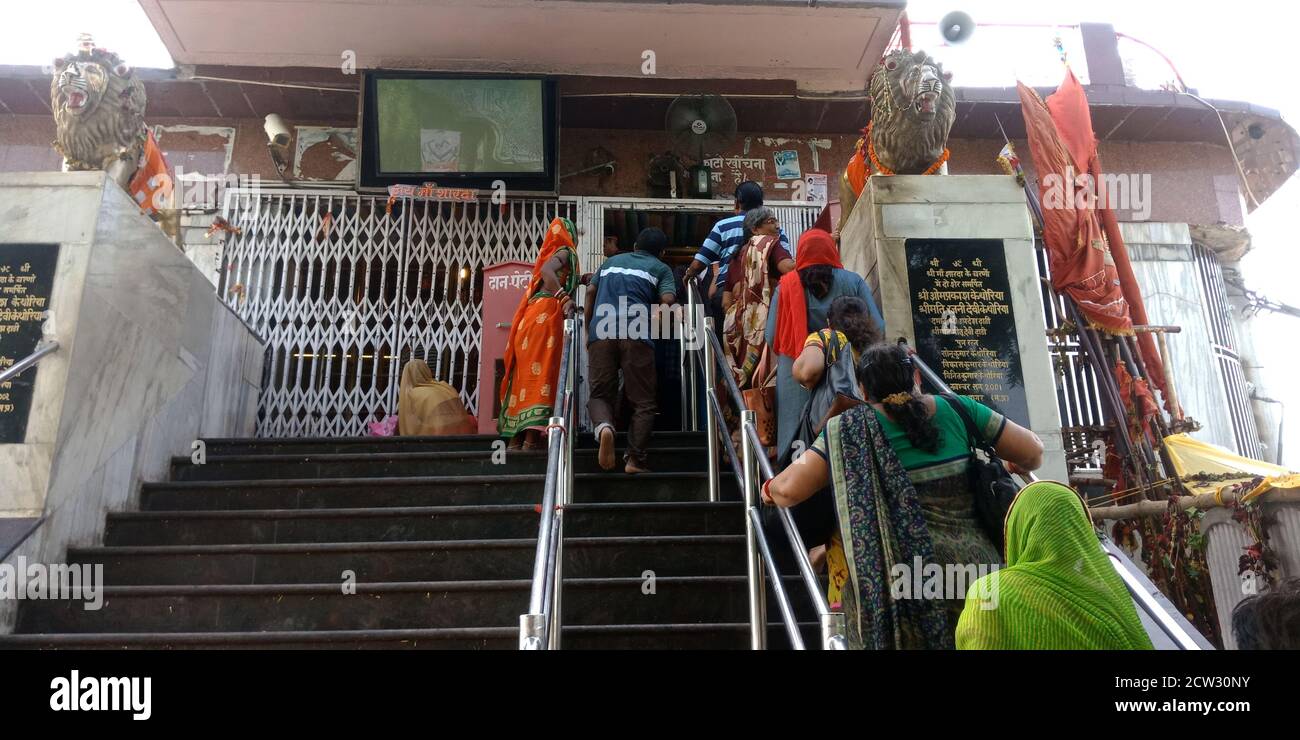 DISTRICT SATNA, INDIA - SEPTEMBER 13, 2019: Indian village people going on stairs at Hindu religious Maihar Sharda holy mother temple. Stock Photo