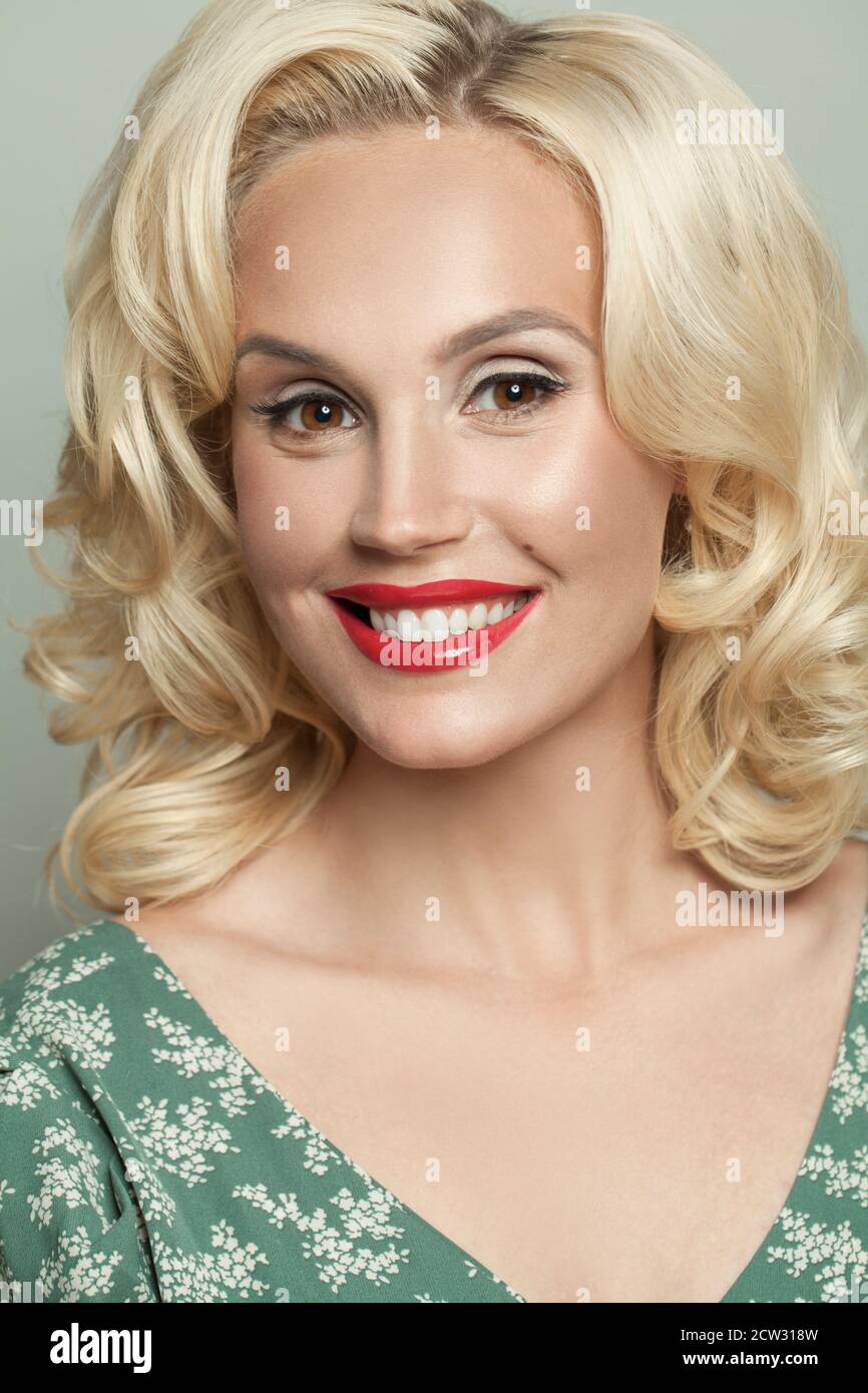 Cute blonde woman with curly hair and makeup Stock Photo