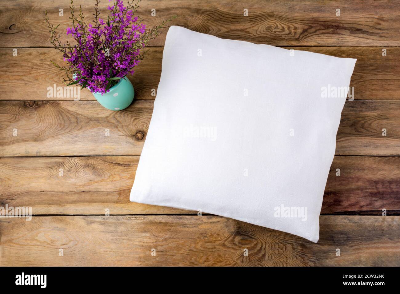 https://c8.alamy.com/comp/2CW32N6/square-cotton-pillow-mockup-with-purple-wildflowers-rustic-linen-pillowcase-mock-up-for-design-presentation-2CW32N6.jpg
