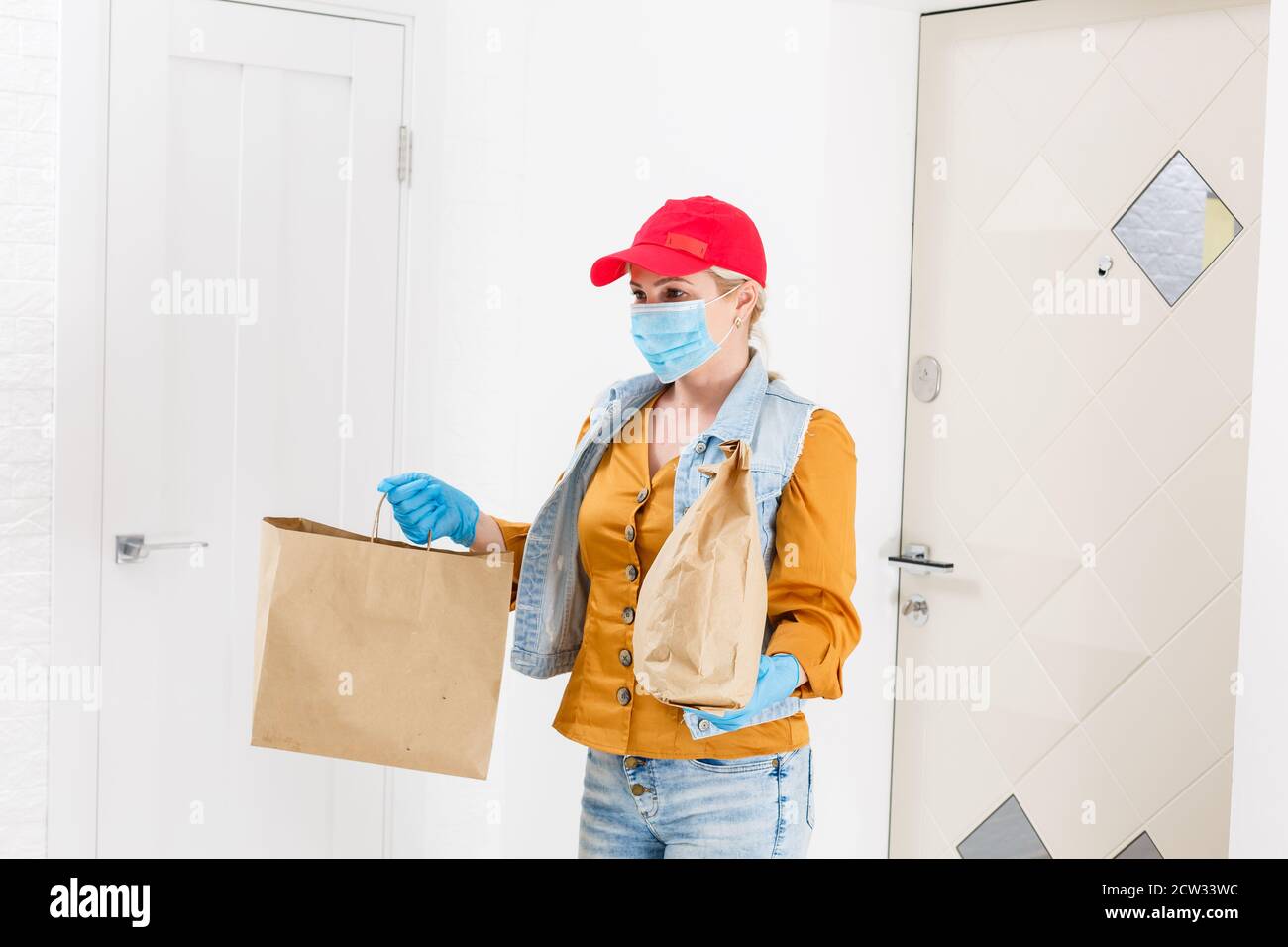 masked delivery woman delivers food during virus outbreak, coronavirus ...