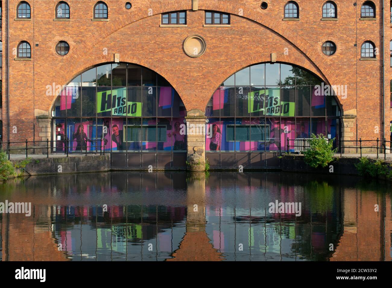Hits Radio entrance, Castlefield, Manchester, UK with reflection in
